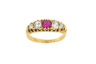 An 18 Carat Gold Ruby and Diamond Five Stone Ring the round cut ruby flanked by graduated old cut