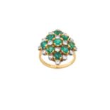 A 14 Carat Gold Emerald and Diamond Cluster Ring the kite motif comprising of emerald-cut emeralds