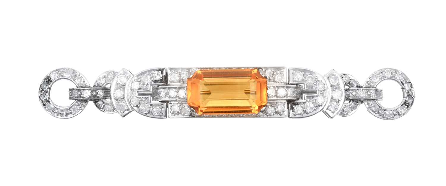 A Citrine and Diamond Brooch the emerald-cut citrine within a geometric border of eight-cut