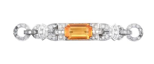 A Citrine and Diamond Brooch the emerald-cut citrine within a geometric border of eight-cut