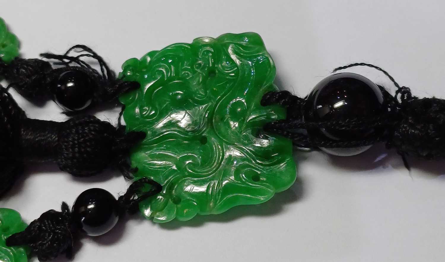 A Jade and Onyx Tassel Necklace an onyx bead suspends a rectangular carved and pierced jade - Image 7 of 16