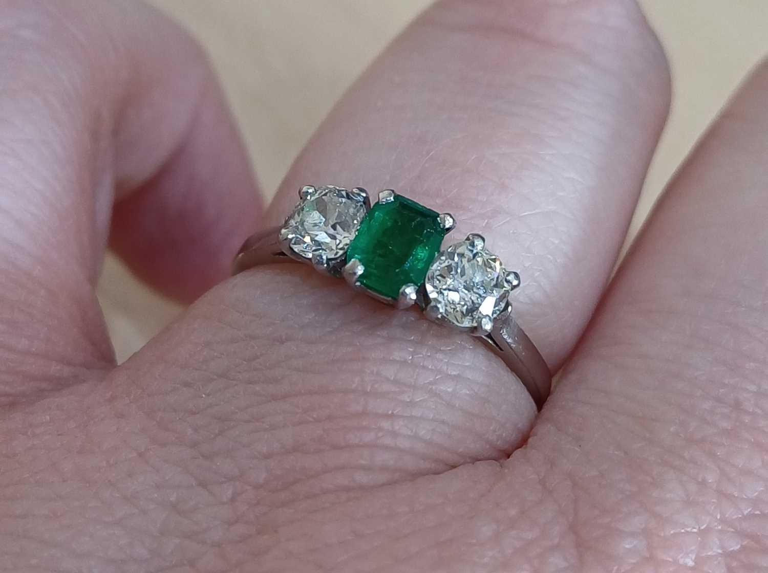 An Emerald and Diamond Three Stone Ring the emerald-cut emerald flanked by old cut diamonds, in - Image 3 of 4