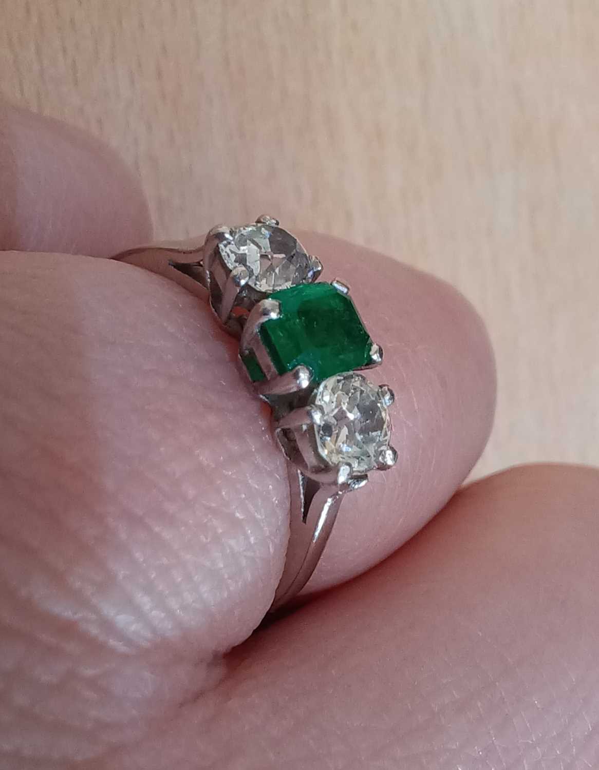 An Emerald and Diamond Three Stone Ring the emerald-cut emerald flanked by old cut diamonds, in - Image 4 of 4