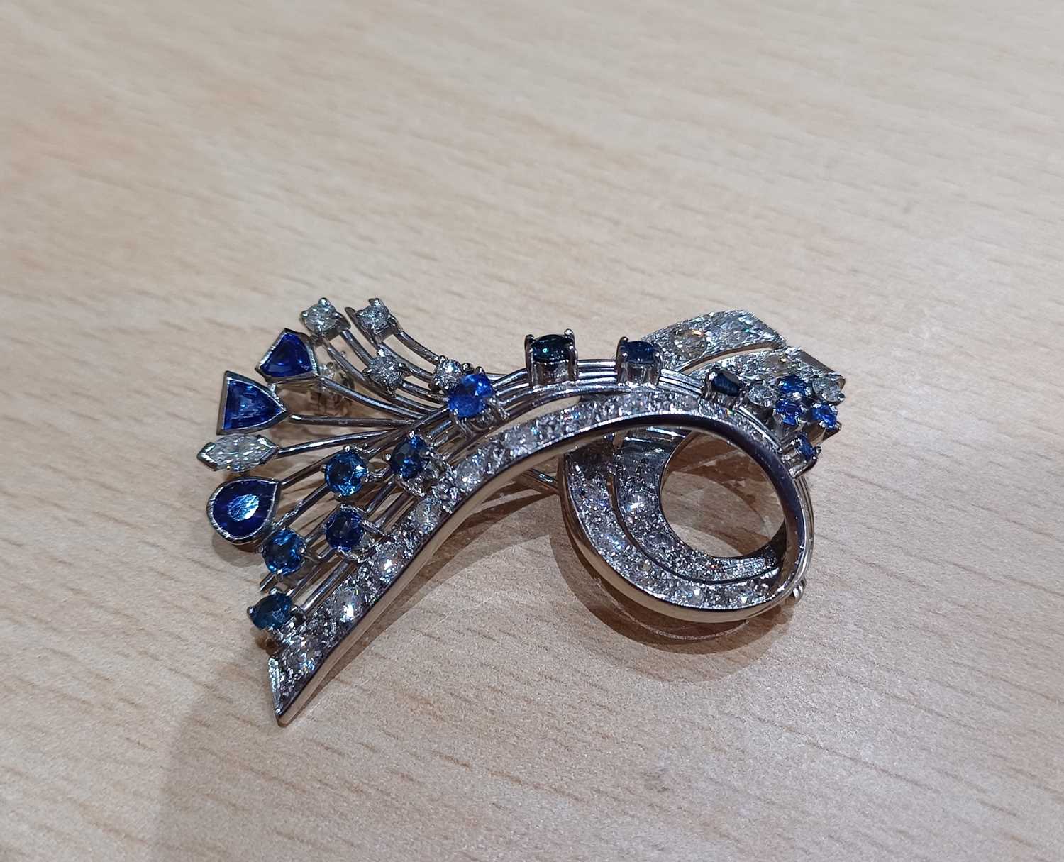 A Sapphire and Diamond Brooch modelled as a ribbon motif, set throughout with vari-shaped - Image 4 of 4