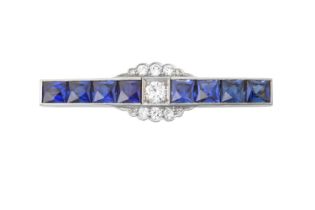 A Synthetic Sapphire and Diamond Brooch the central round brilliant cut diamond flanked by four