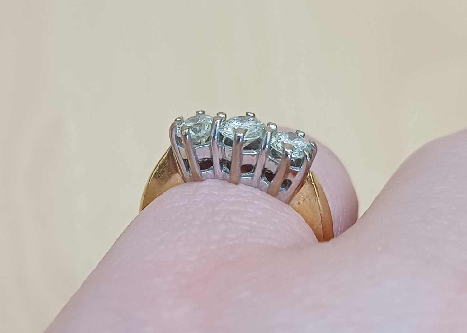 An 18 Carat Gold Diamond Three Stone Ring the round brilliant cut diamonds in white claw settings, - Image 3 of 5