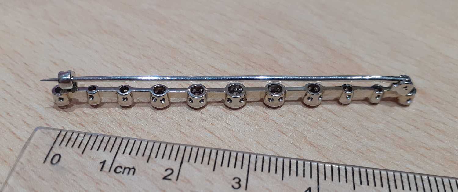 A Diamond Bar Brooch the white knife edge bar overlaid with eleven graduated old cut diamonds, in - Image 3 of 3