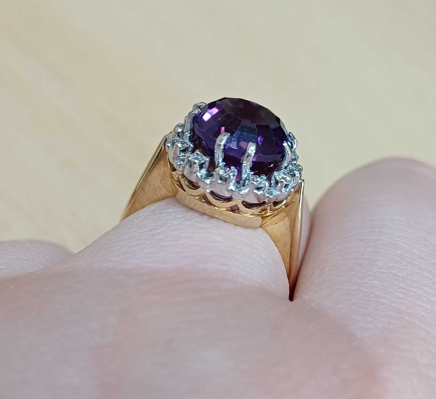 An Amethyst and Diamond Cluster Ring the round cut amethyst within a border of round brilliant cut - Image 3 of 4