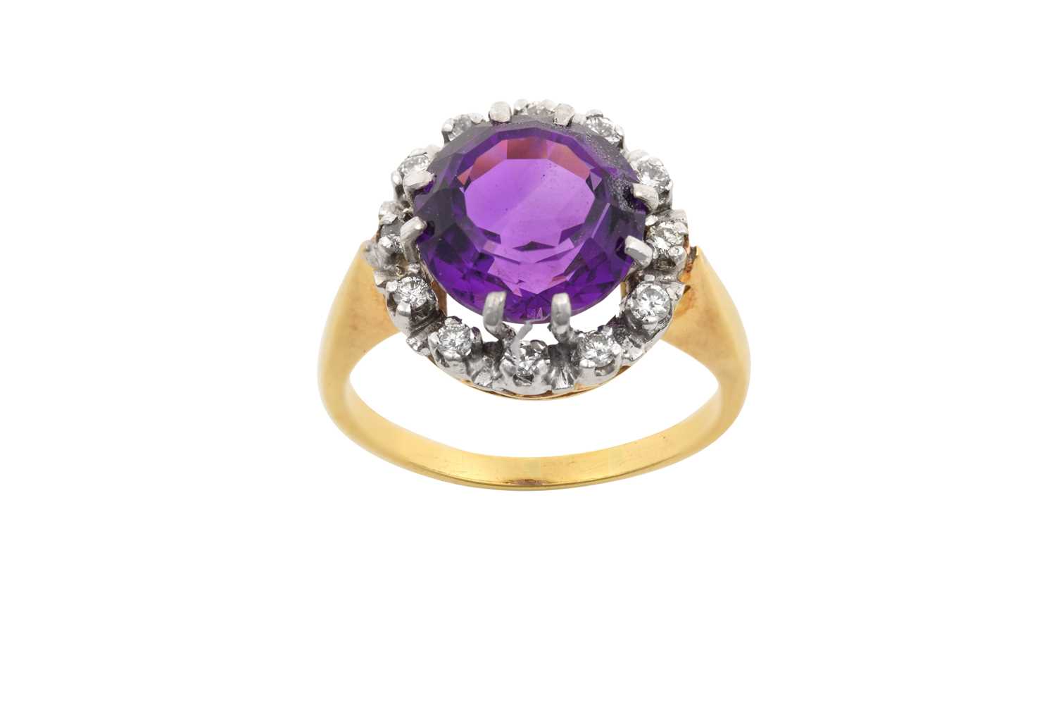 An Amethyst and Diamond Cluster Ring the round cut amethyst within a border of round brilliant cut