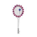 A Ruby, Sapphire and Diamond Novelty Brooch realistically modelled as a tennis racket, the white