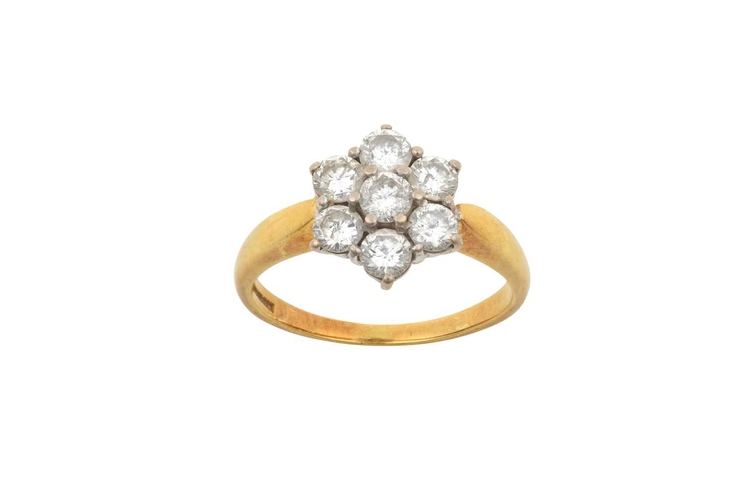 An 18 Carat Gold Diamond Cluster Ring the central raised round brilliant cut diamond within a border