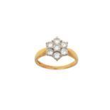 An 18 Carat Gold Diamond Cluster Ring the central raised round brilliant cut diamond within a border