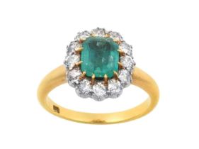 An Emerald and Diamond Cluster Ring the emerald-cut emerald in a yellow claw setting, within a