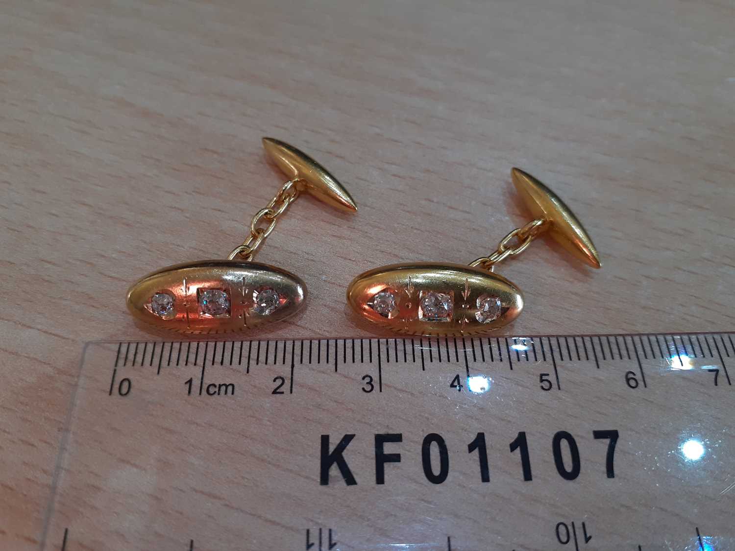 A Pair of Diamond Cufflinks the yellow domed oval plaque inset with three old cut diamonds, chain - Image 2 of 3
