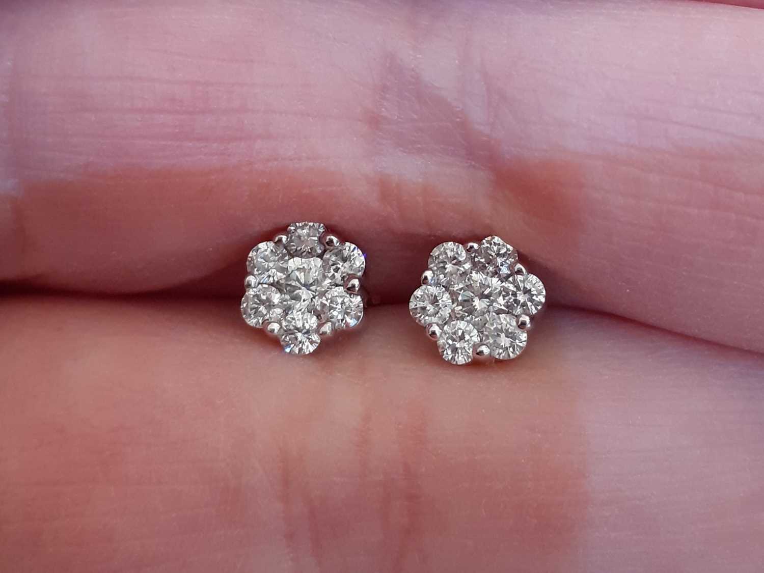 A Pair of Diamond Cluster Earrings the clusters formed of round brilliant cut diamonds, in white - Image 2 of 3