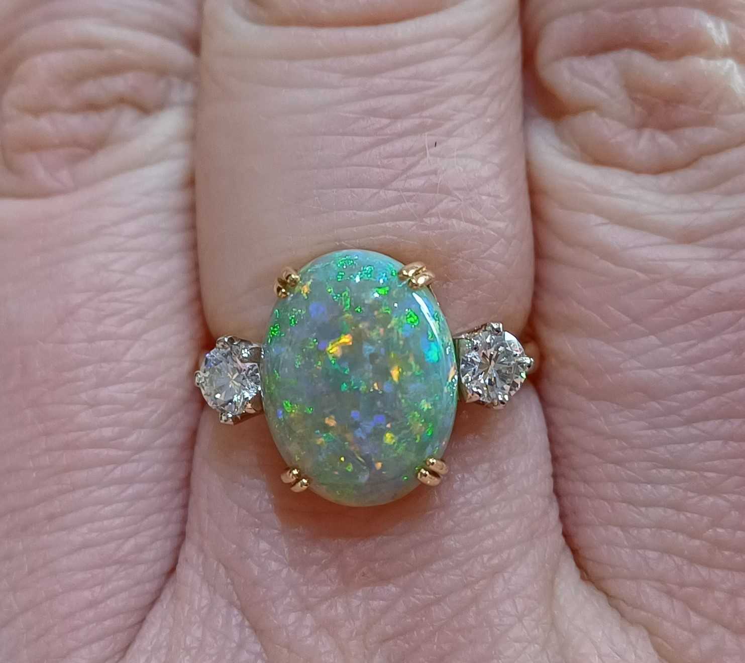 An 18 Carat Gold Opal and Diamond Three Stone Ring the oval cabochon opal in a yellow double claw - Image 3 of 4