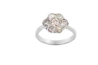 A Diamond Cluster Ring the central old cut diamond within a border of smaller old cut diamonds, in