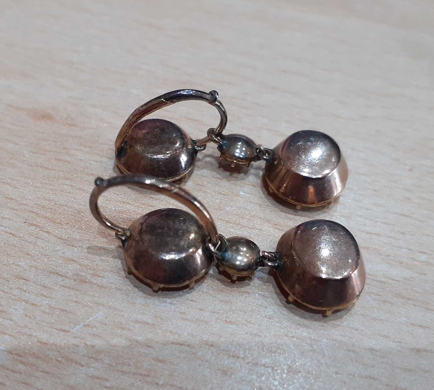 A Pair of Garnet Drop Earrings a round cut garnet suspends a smaller round cut garnet and an oval - Image 3 of 3