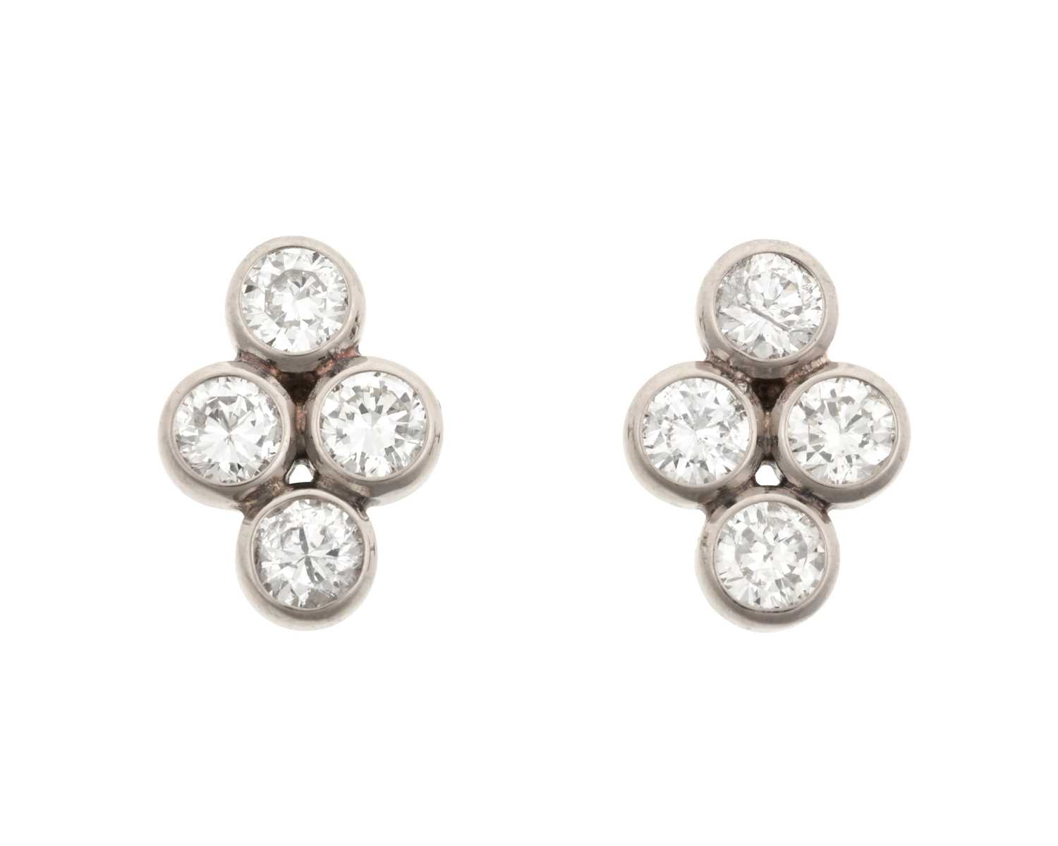 A Pair of Diamond Cluster Earrings four round brilliant cut diamonds in white rubbed over