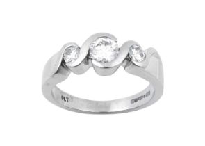 A Platinum Diamond Three Stone Ring the graduated round brilliant cut diamonds in white rubbed