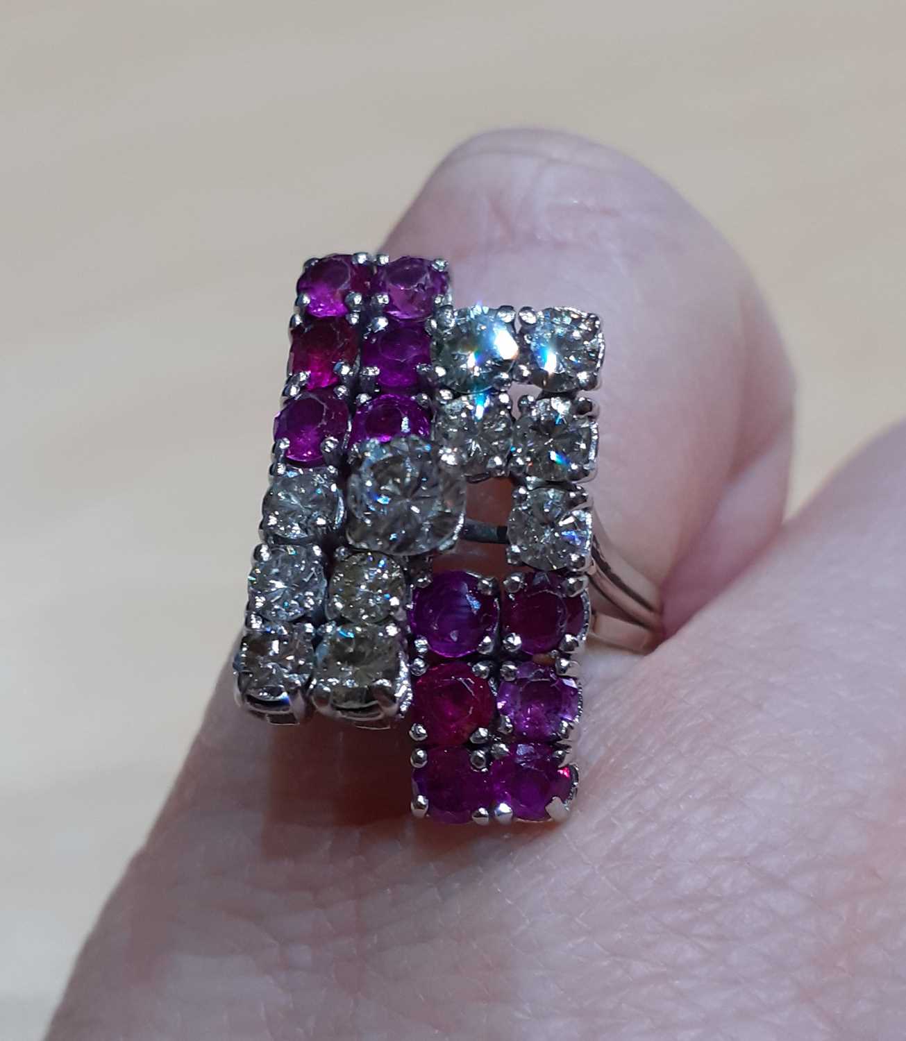 A Ruby and Diamond Cluster Ring a raised round brilliant cut diamond, to a geometric motif, formed - Image 2 of 6