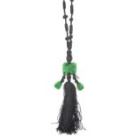 A Jade and Onyx Tassel Necklace an onyx bead suspends a rectangular carved and pierced jade