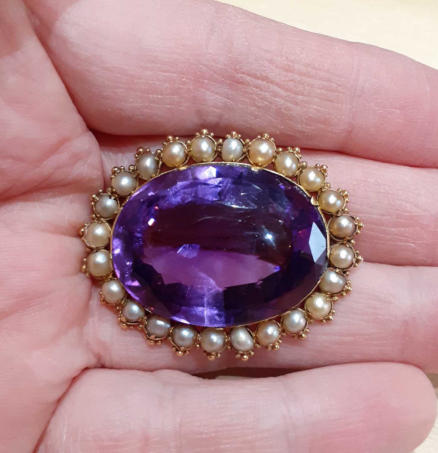 An Amethyst and Split Pearl Brooch the oval cut amethyst within a border of split pearls, in - Image 2 of 4