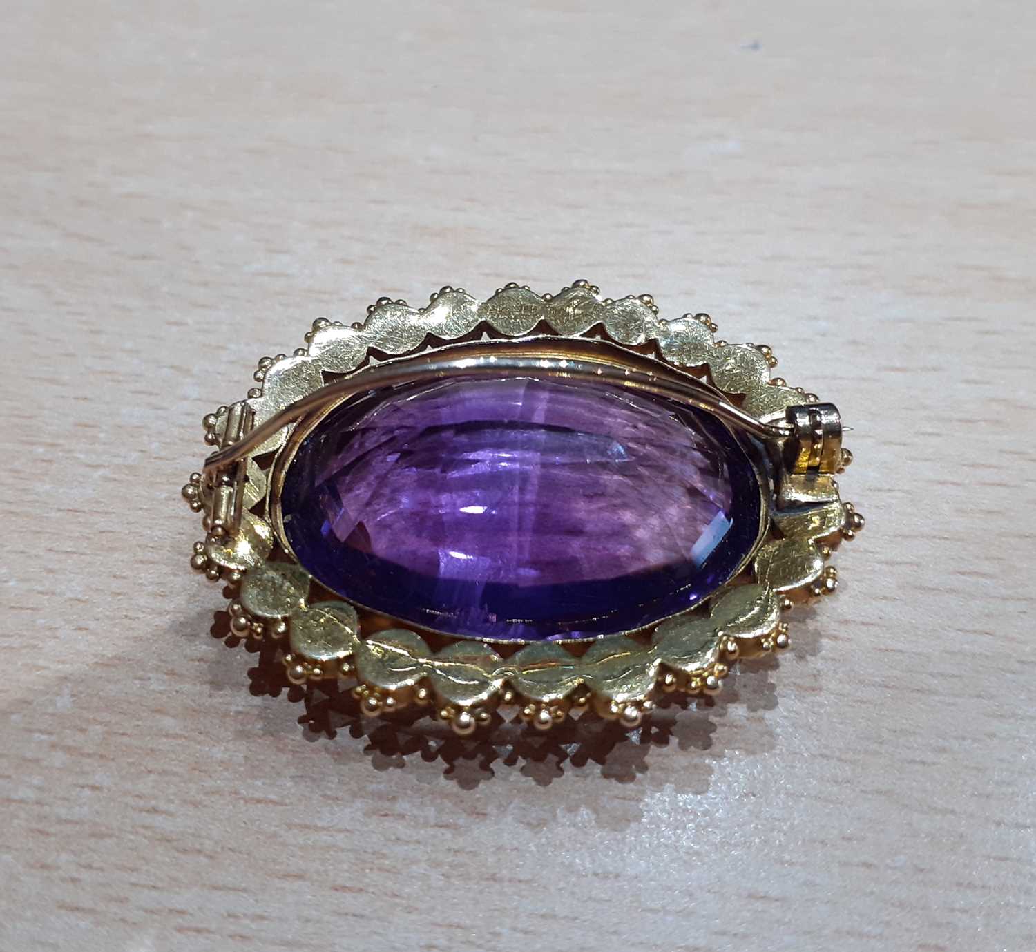 An Amethyst and Split Pearl Brooch the oval cut amethyst within a border of split pearls, in - Image 4 of 4