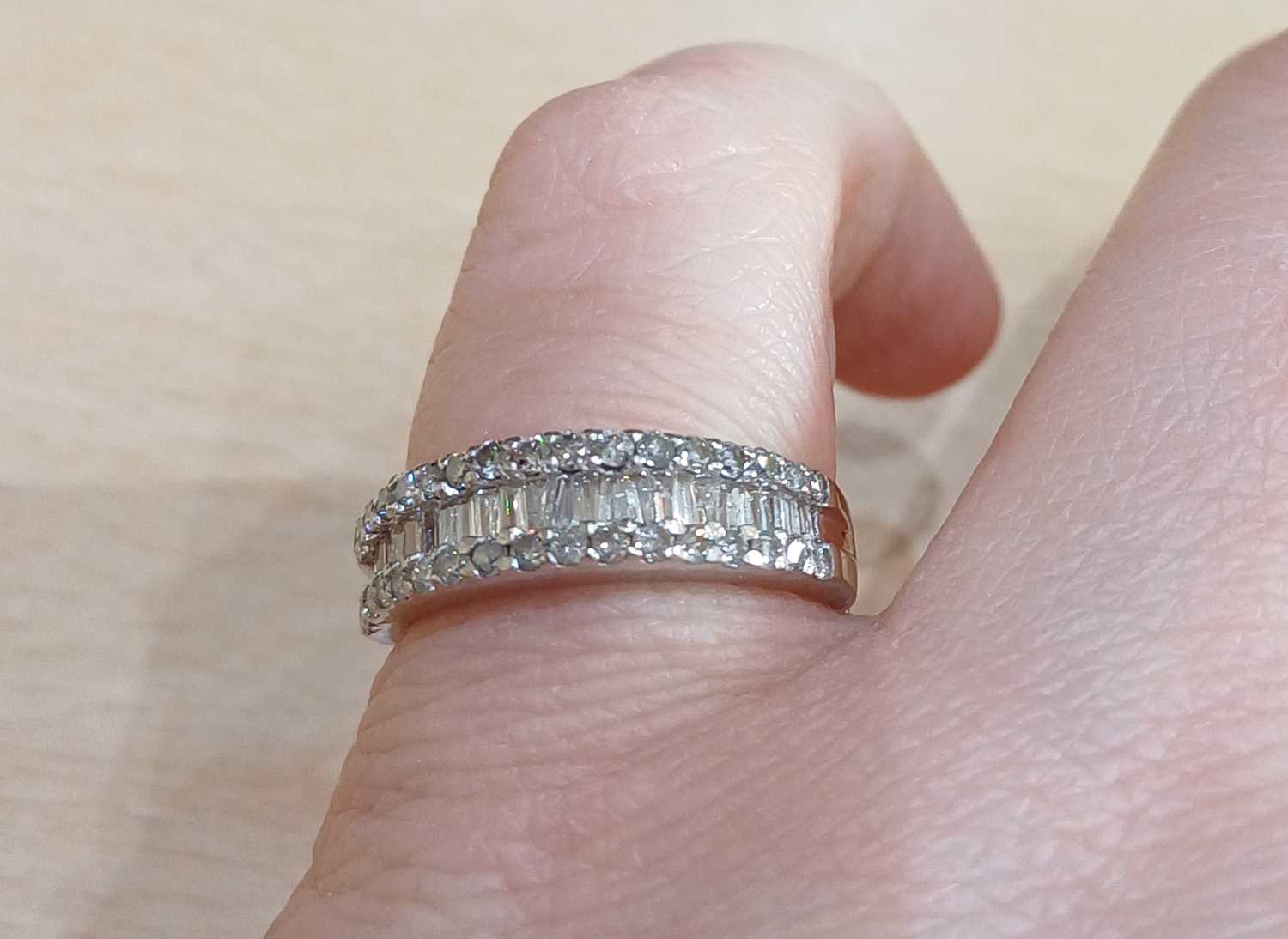 A Diamond Half Hoop Ring a row of tapered baguette cut diamonds within two rows of round brilliant - Image 2 of 4