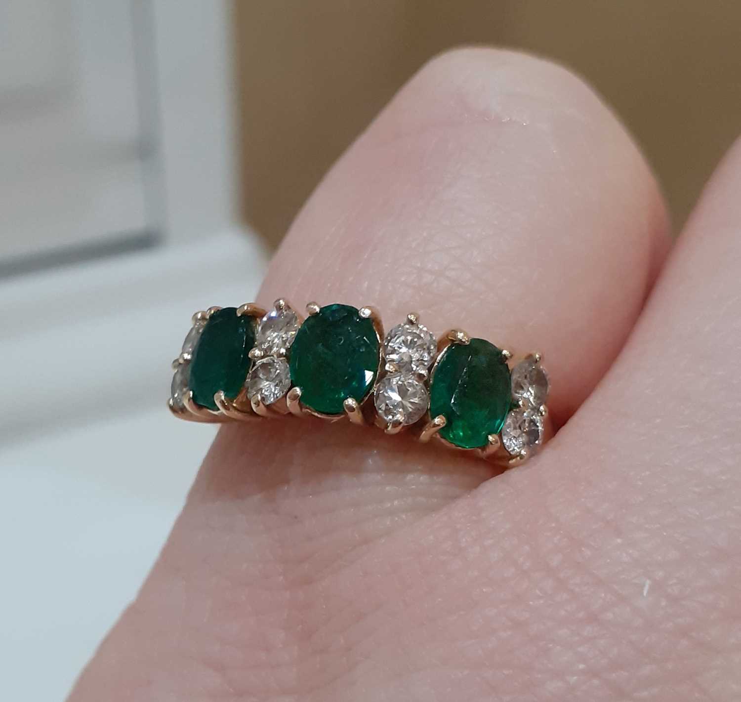 An Emerald and Diamond Ring three oval cut emeralds spaced by pairs of round brilliant cut diamonds, - Image 2 of 4