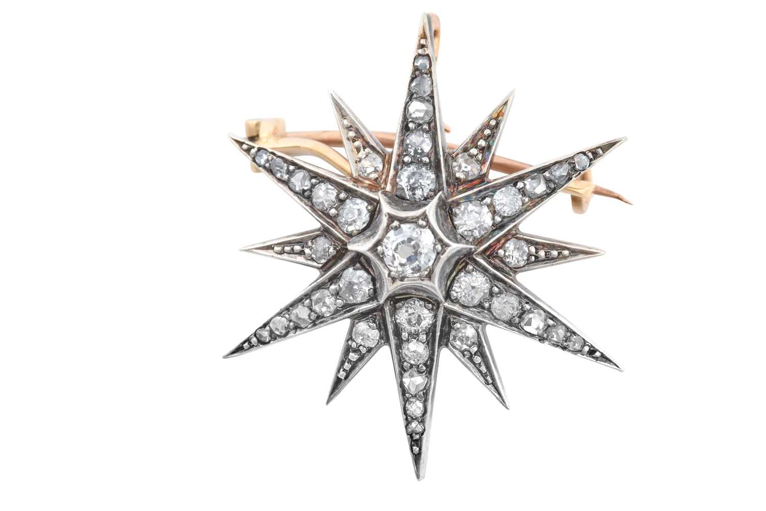A Victorian Diamond Star Brooch/Pendant, circa 1880 an old cut diamond centres twelve radial arms,