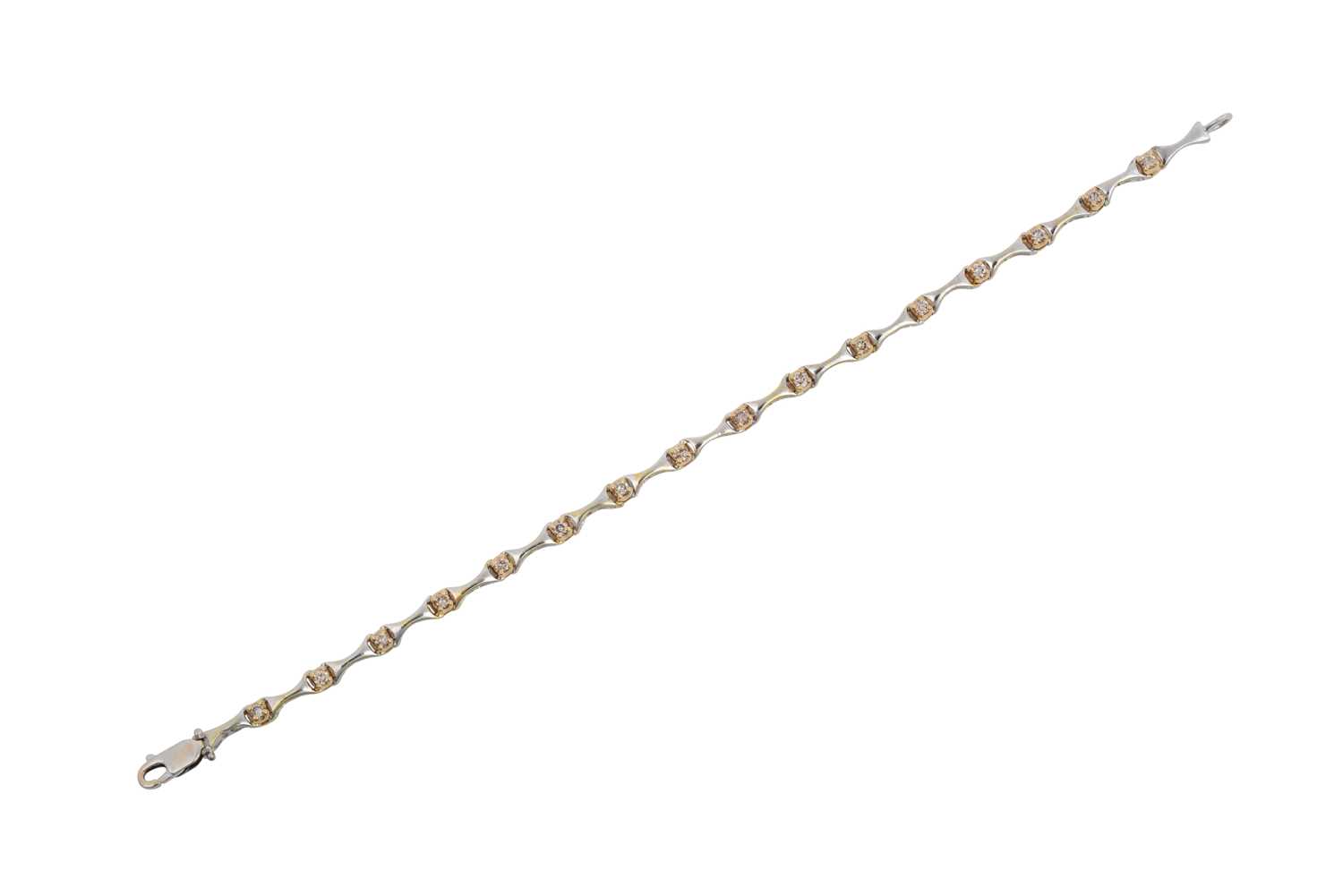 A Diamond Bracelet white tapered bars spaced by round brilliant cut diamonds in yellow claw