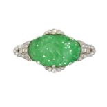 An Art Deco Jade and Diamond Brooch the oval pierced and carved jade plaque depicting birds
