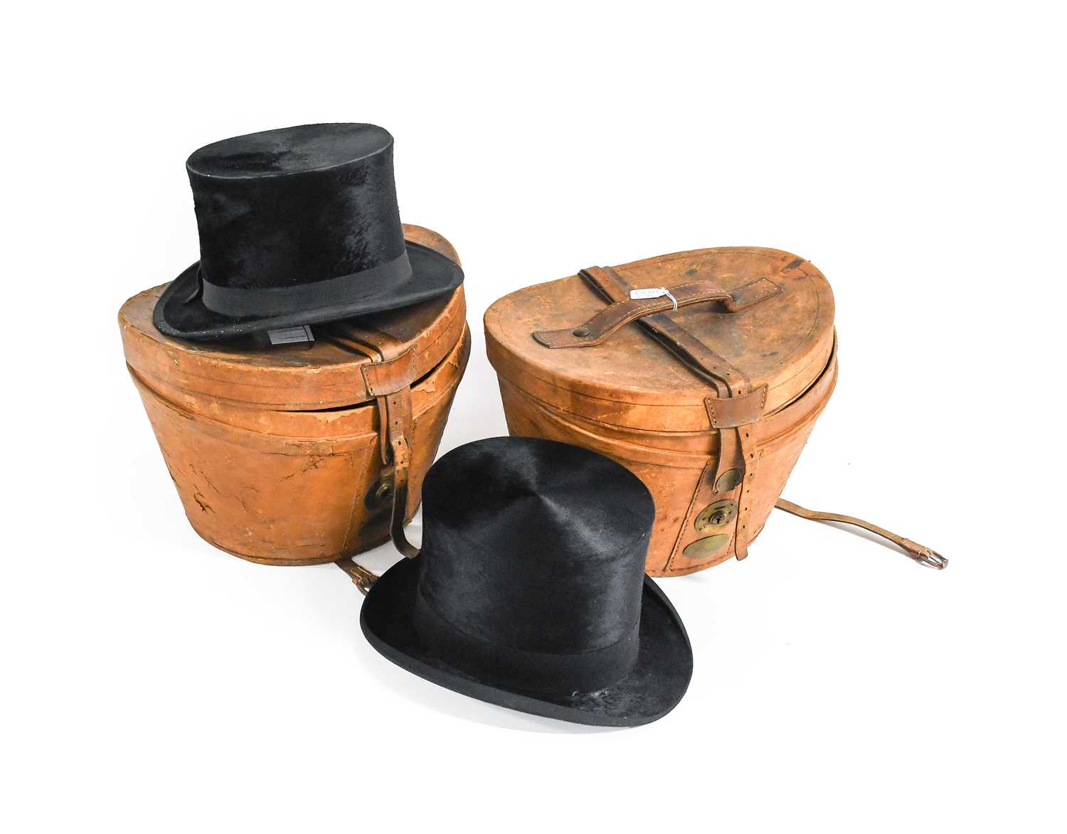 Henry Heath London Black Silk Top Hat in a fitted leather case with red cotton lining, Another in