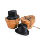 Henry Heath London Black Silk Top Hat in a fitted leather case with red cotton lining, Another in