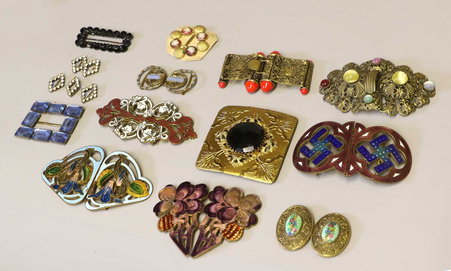 Decorative 20th Century Belt Buckles, comprising four pairs of floral and scrolling enamel decorated