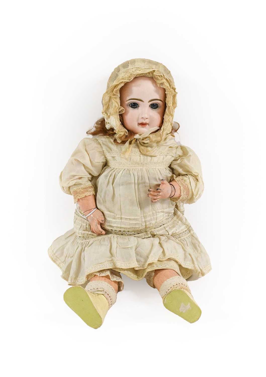 A French Tete Jumeau Bisque Socket Head Bebe Doll, with fixed blue glass paper-weight eyes, finely