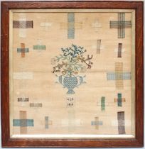 A 19th Century Darning Sampler, depicting a twin handled vase of flowers to the centre, with