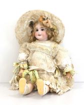 A French Tete Jumeau Bisque Socket Head Bebe Doll, with fixed blue glass paper-weight eyes, finely