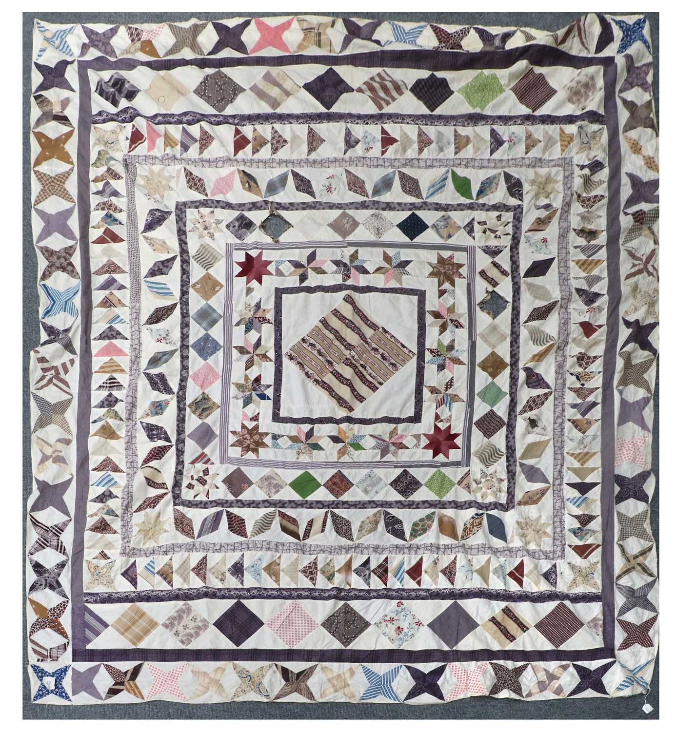 Early 19th Century Patchwork Cover, on a white cotton ground decorated with a central diamond within