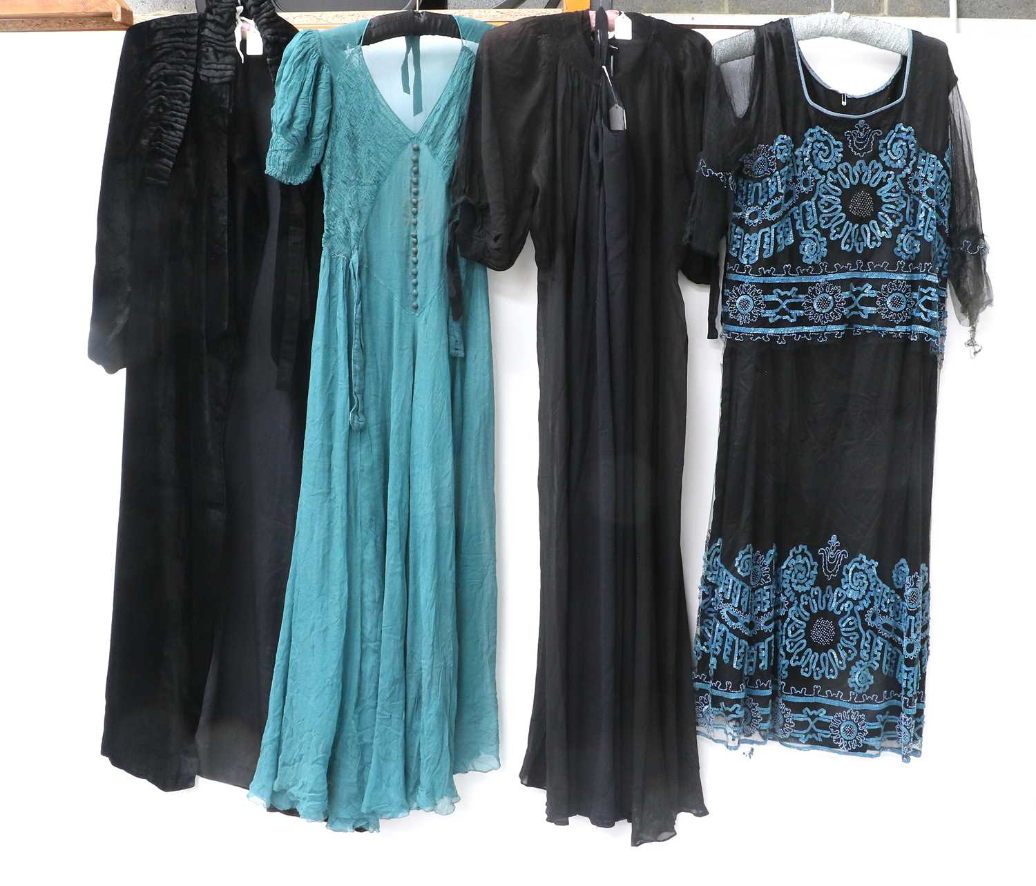 Circa 1920s Ladies Evening Dresses comprising a black silk dress with black net mount, blue sequin