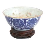 A Chinese Porcelain Punch Bowl, 19th century, with everted rim edged in copper glaze, painted in