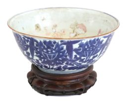 A Chinese Porcelain Punch Bowl, 19th century, with everted rim edged in copper glaze, painted in