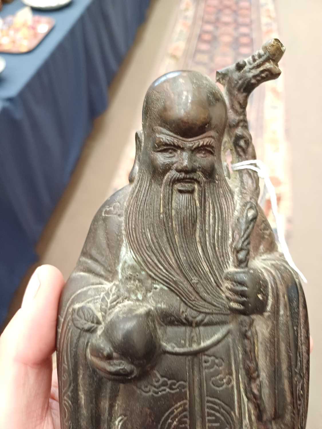 A Chinese Bronze Figure of Shoulao, in Ming style, standing wearing flowing robes holding his - Image 24 of 26