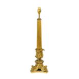 A Gilt Bronze Lamp Base, the fluted tapering column with basal acanthus sheathing, on a tricorn