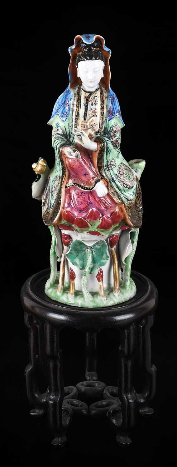 A Chinese Porcelain Figure of Guanyin, Qing Dynasty, late 18th/19th century, typically modelled