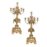 A Pair of French Gilt Bronze Seven-Light Candelabra, in Louis XIV style, with urn sockets on leaf-