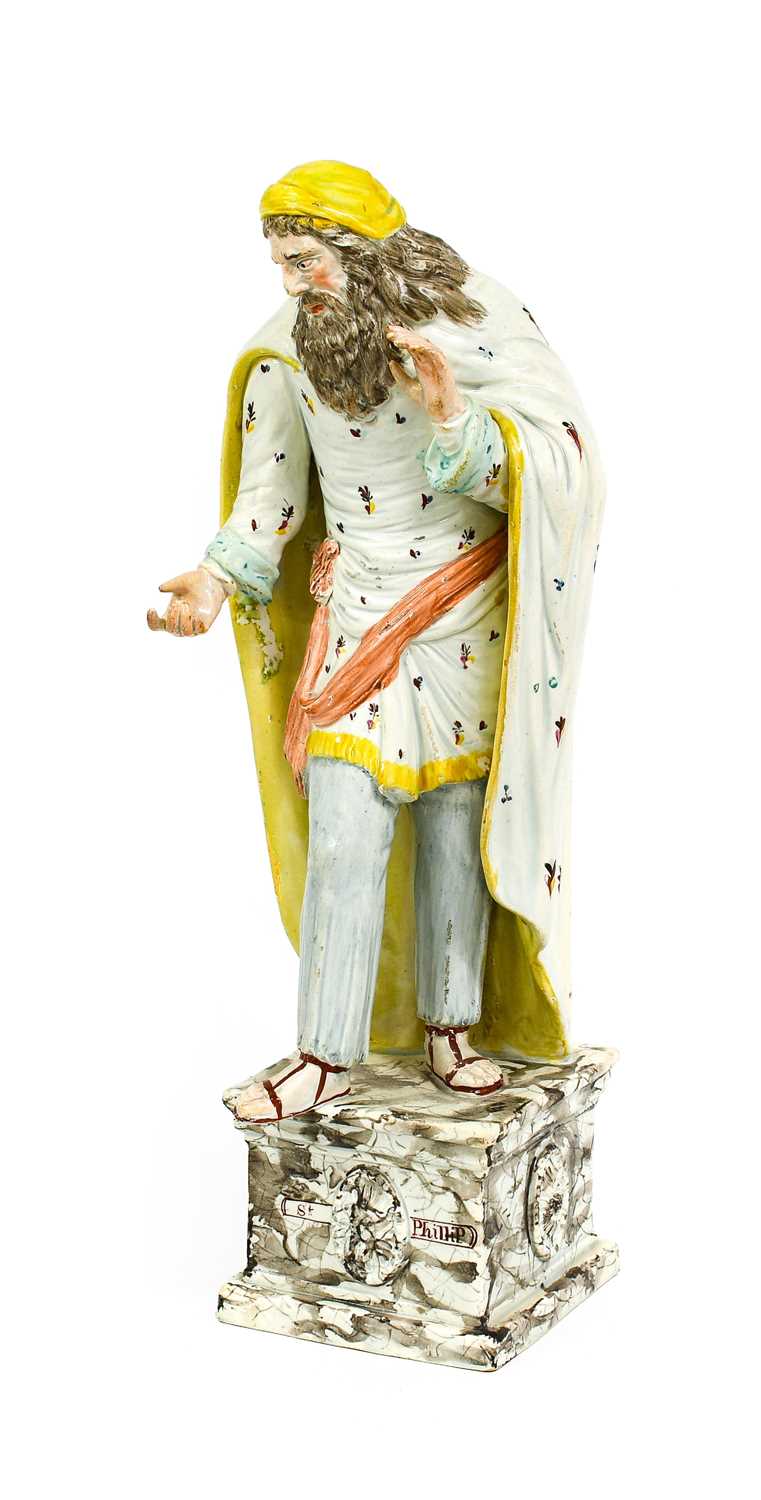 A Staffordshire Pearlware Figure of St Philip, circa 1810, the bearded figure stood wearing a long