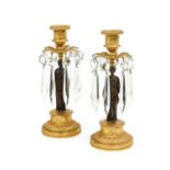 A Pair of French Gilt and Patinated Bronze Figural Candlesticks, in Empire style, the urn-shape