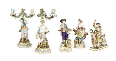 A Pair of Sitzendorf Porcelain Figural Candlesticks, 19th century, a young man harvesting corn